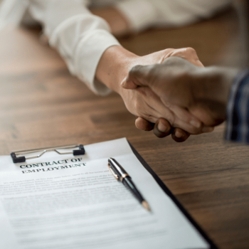 New hire shaking hands with employer.