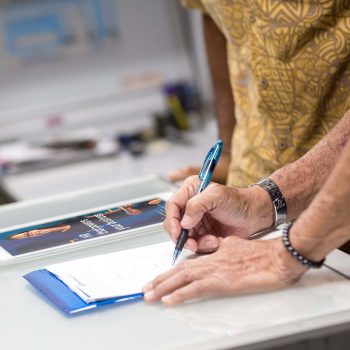 man writes on notebook